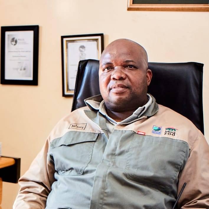 Portrait of Dr Piet Malepa seated in his office